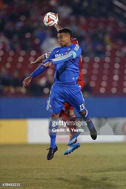 Matteo Ferrari of Montreal Impact defends the ball from the FC Dallas defense at Toyota Stadium on March 8, 2014 in Frisco, Texas.