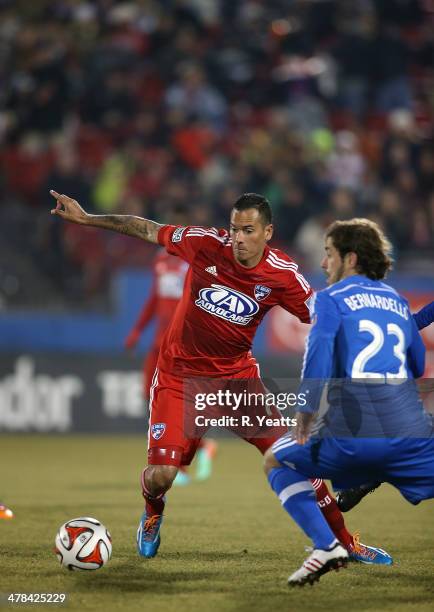 Blas Perez of FC Dallas defends the ball from Hernan Bernardello of Montreal Impact at Toyota Stadium on March 8, 2014 in Frisco, Texas.
