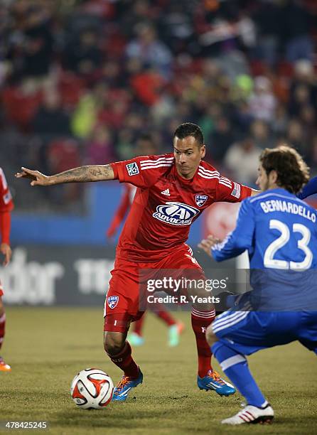 Blas Perez of FC Dallas defends the ball from Hernan Bernardello of Montreal Impact at Toyota Stadium on March 8, 2014 in Frisco, Texas.