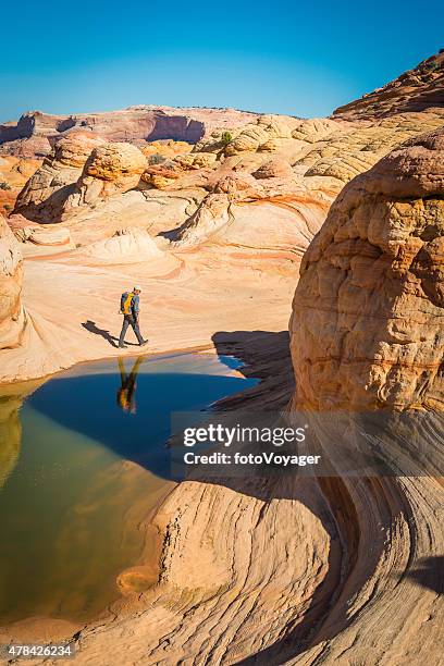 male hiker exploring picturesque desert wilderness the wave arizona utah - the wave utah stock pictures, royalty-free photos & images