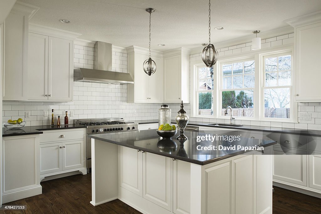 Modern white kitchen with lights off