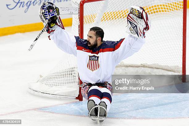 Steve Cash of USA celebrates victory during the Ice Sledge Hockey semifinal match between Canada and USA at Shayba Arena during day six of the 2014...