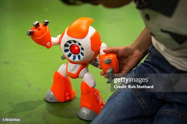 Miraan Jawed plays with a 'i-Que' robot at Hamleys on June 25, 2015 in London, England. The talking robot, which reponses to questions, sells for...