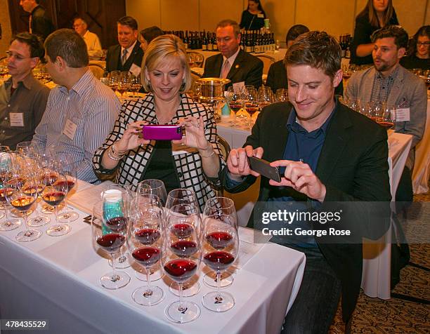 Couple takes iPhone phots of glasses of wine during a tasting at the Montage Hotel on March 3 in Beverly Hills, California. Millions of tourists...