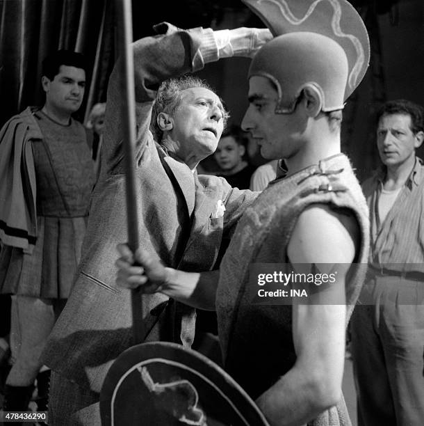 Jean Cocteau adjusts the costume of guard which carries Charles Denner the shooting of ""The Infernal machine""