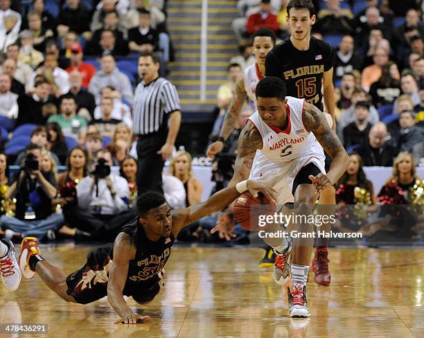 Ian Miller of the Florida State Seminoles and Nick Faust of the Maryland Terrapins battle for a loose ball during the second round of the 2014 Men's...