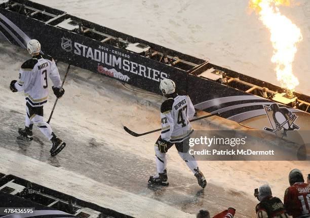 Simon Despres and Olli Maatta of the Pittsburgh Penguins walk to the ice during the 2014 NHL Stadium Series game against the Chicago Blackhawks on...