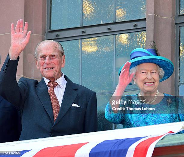 Prince Philip, Duke of Edingburgh and Queen Elizabeth II wave to the crowd from the balcony of the city hall 'Roemer' on June 25, 2015 in Frankfurt...