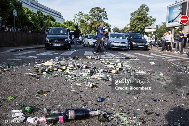 Broken glass bottles and debris litter a road as French cab drivers protest against Uber Technologies Inc.'s car sharing service in Paris, France, on...