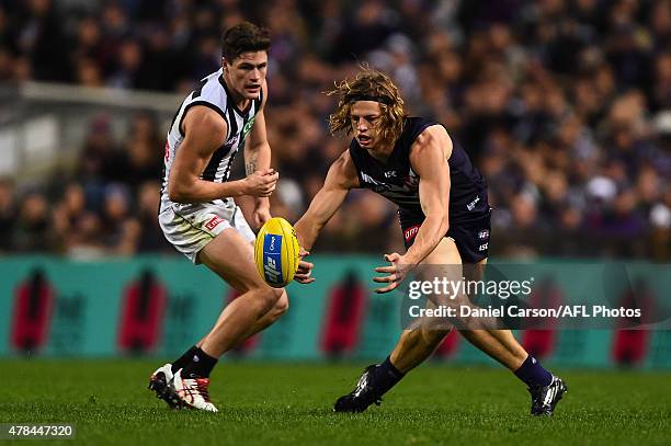 Nathan Fyfe of the Fremantle Dockers gathers the ball during the 2015 AFL round thirteen match between the Fremantle Dockers and the Collingwood...