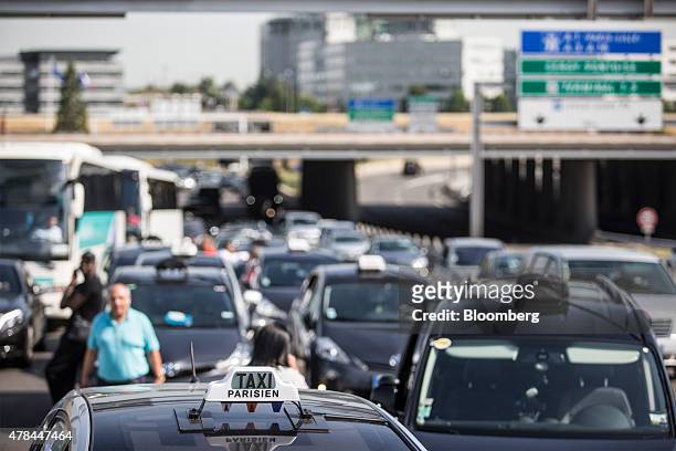 French cab drivers block roads outside Charles de Gaulle airport during a protest against Uber Technologies Inc.'s car sharing service in Roissy,...