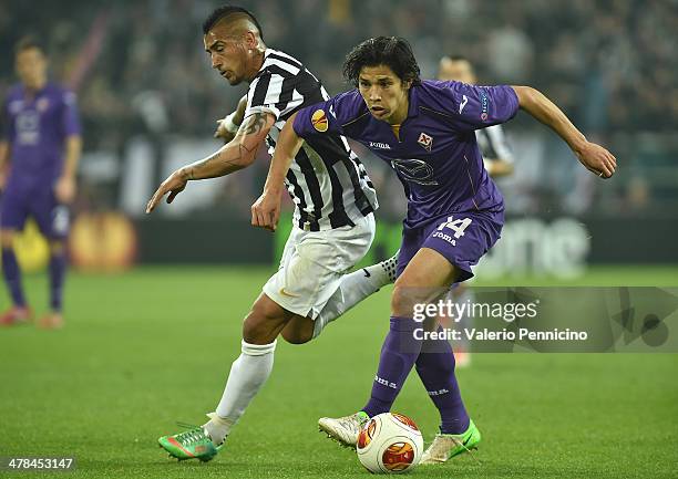 Arturo Vidal of Juventus competes with Matias Fernandez of ACF Fiorentina during the UEFA Europa League Round of 16 match between Juventus and ACF...