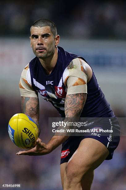 Clancee Pearce of the Dockers handballs during the round 13 AFL match between the Fremantle Dockers and the Collingwood Magpies at Domain Stadium on...