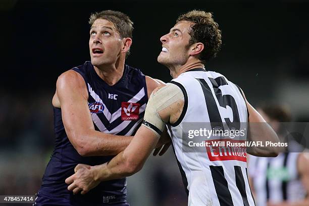 Aaron Sandilands of the Dockers contests a ruck with Jarrod Witts of the Magpies during the round 13 AFL match between the Fremantle Dockers and the...