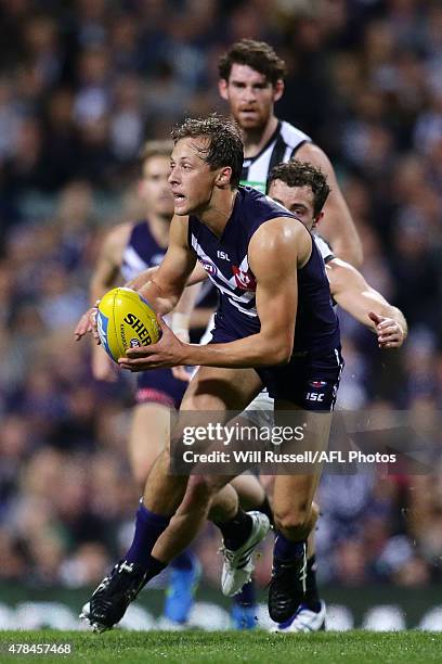 Cameron Sutcliffe of the Dockers handballs during the round 13 AFL match between the Fremantle Dockers and the Collingwood Magpies at Domain Stadium...