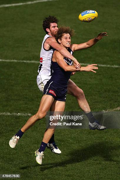 Tyson Goldsack of the Magpies and Chris Mayne of the Dockers contest the ball during the round 13 AFL match between the Fremantle Dockers and the...