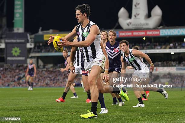 Scott Pendlebury of the Magpies looks to pass the ball during the round 13 AFL match between the Fremantle Dockers and the Collingwood Magpies at...