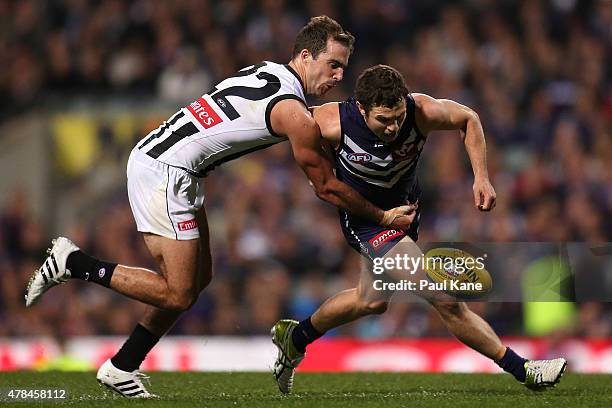 Steele Sidebottom of the Magpies and Hayden Ballantyne of the Dockers contest for the ball during the round 13 AFL match between the Fremantle...