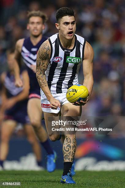 Marley Williams of the Magpies handballs during the round 13 AFL match between the Fremantle Dockers and the Collingwood Magpies at Domain Stadium on...