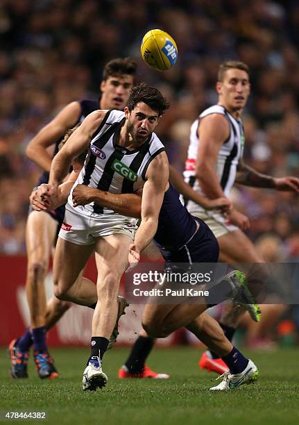 Alex Fasolo of the Magpies handballs during the round 13 AFL match between the Fremantle Dockers and the Collingwood Magpies at Domain Stadium on...