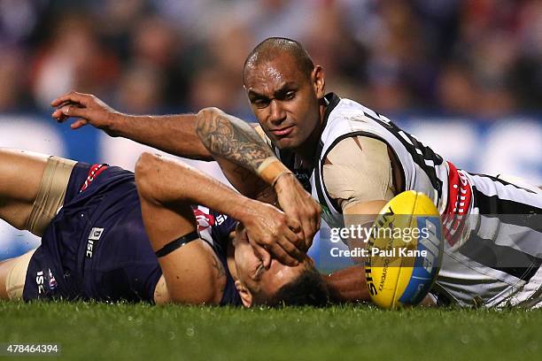 Travis Varcoe of the Magpies tackles Michael Walters of the Dockers during the round 13 AFL match between the Fremantle Dockers and the Collingwood...