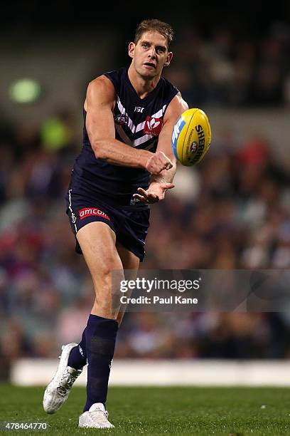 Aaron Sandilands of the Dockers handballs during the round 13 AFL match between the Fremantle Dockers and the Collingwood Magpies at Domain Stadium...