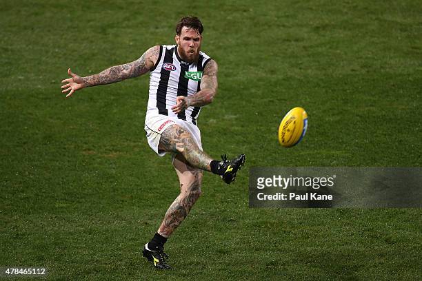 Dane Swan of the Magpies kicks the ball into the forward line during the round 13 AFL match between the Fremantle Dockers and the Collingwood Magpies...