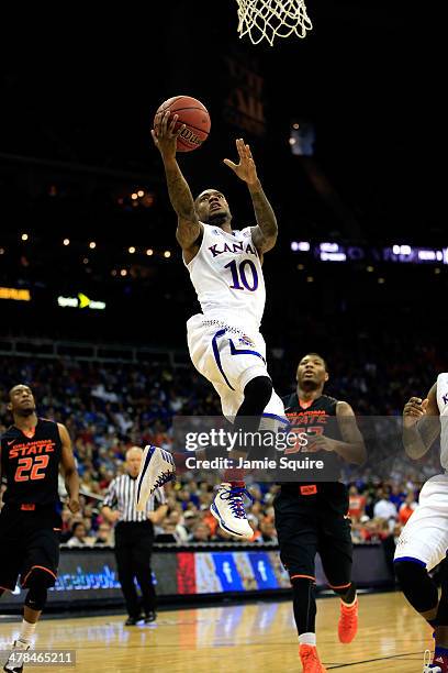 Naadir Tharpe of the Kansas Jayhawks drives to the basket to score during the Big 12 Basketball Tournament quarterfinal game against the Oklahoma...
