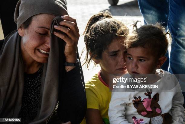 Relatives of wounded people react in front of the hospital of Suruc, Sanliurfa province, on June 25, 2015 after a deadly suicide bombing occurred in...