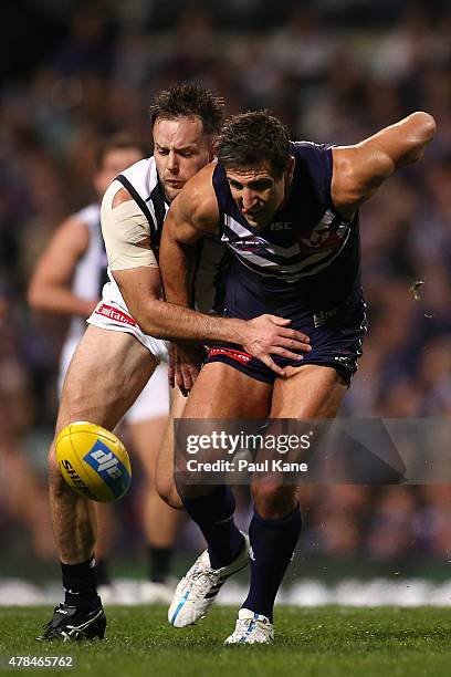 Nathan Brown of the Magpies and Matthew Pavlich of the Dockers contest for the ball during the round 13 AFL match between the Fremantle Dockers and...