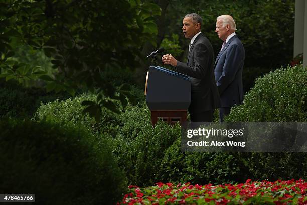 President Barack Obama, flanked by Vice President Joe Biden, gives a statement on the Supreme Court health care decision in the Rose Garden at the...