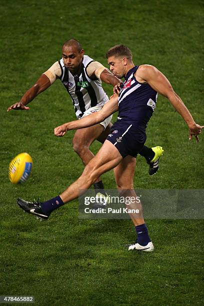 Stephen Hill of the Dockers gets his kick away against Travis Varcoe of the Magpies during the round 13 AFL match between the Fremantle Dockers and...