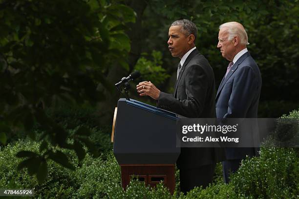 President Barack Obama, flanked by Vice President Joe Biden, gives a statement on the Supreme Court health care decision in the Rose Garden at the...