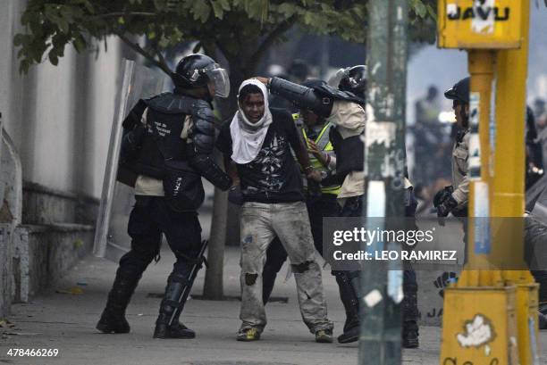 An anti-government activist is arrested by national police during a protest against Venezuela President Nicolas Maduro government in Caracas on March...