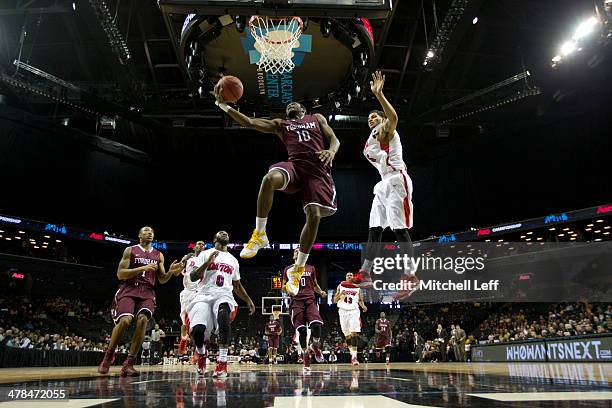 Guard Jon Severe of the Fordham Rams attempts a layup against the Dayton Flyers in the second round of the men's Atlantic 10 tournament on March 13,...