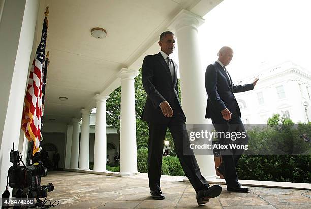 President Barack Obama leaves with Vice President Joe Biden after he gave a statement on the Supreme Court health care decision in the Rose Garden at...