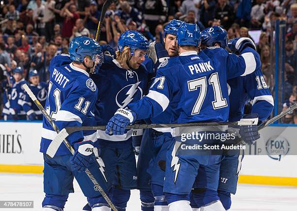 Mike Kostka of the Tampa Bay Lightning celebrates his goal with teammates Tom Pyatt and Richard Panik during the first period against the Florida...