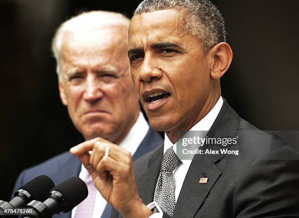 President Barack Obama , flanked by Vice President Joe Biden , gives a statement on the Supreme Court health care decision in the Rose Garden at the...