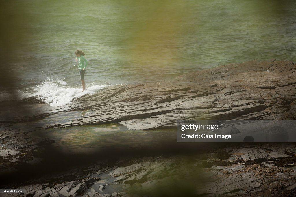 Woman standing on rocks at beach