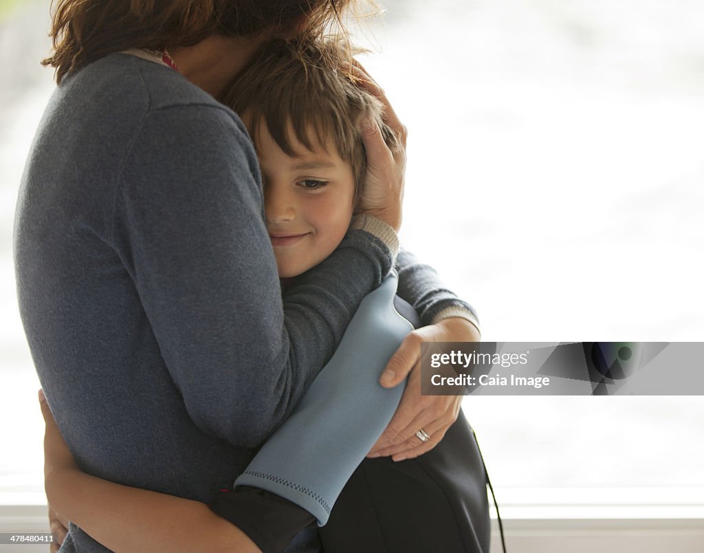 Mother and son hugging