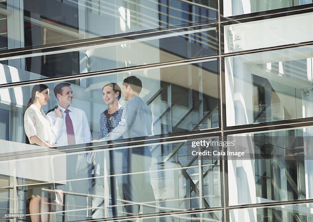 Business people talking at window