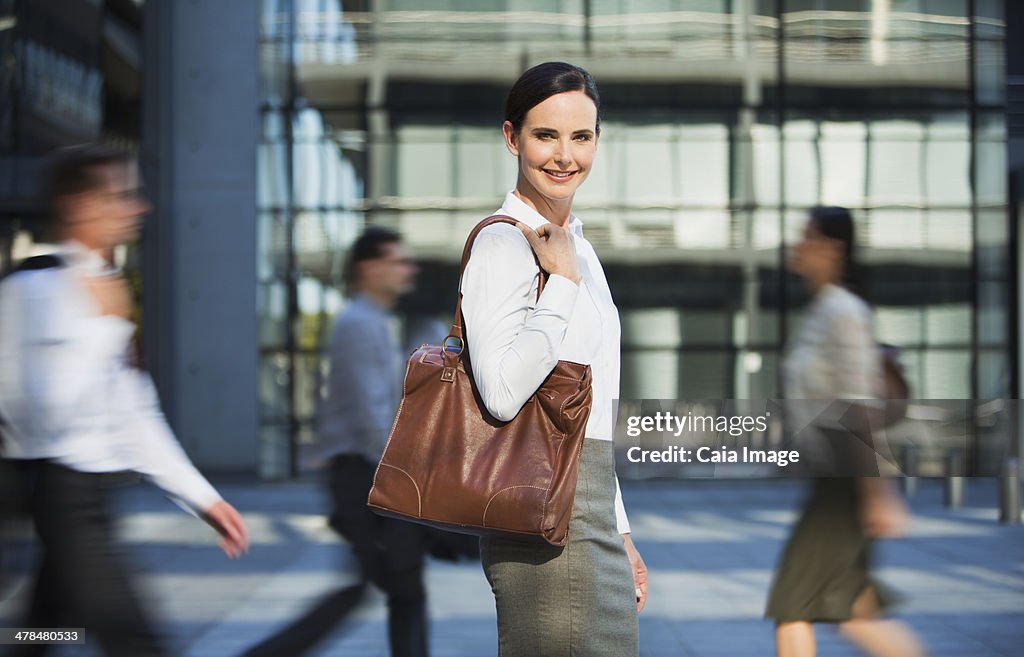 Smiling businesswoman outside urban building