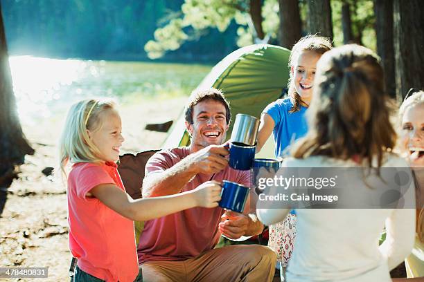 smiling family toasting mugs at campsite - african africa child drinking water cup stock pictures, royalty-free photos & images