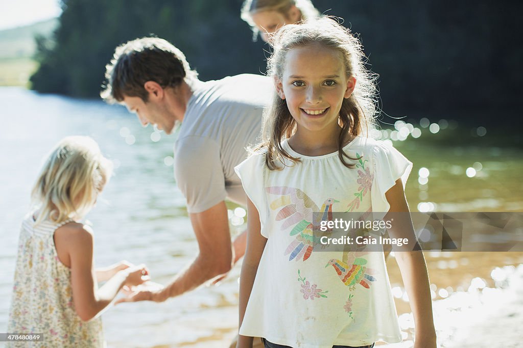 Smiling girl with family at lakeside