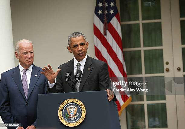 President Barack Obama , flanked by Vice President Joe Biden , gives a statement on the Supreme Court health care decision in the Rose Garden at the...