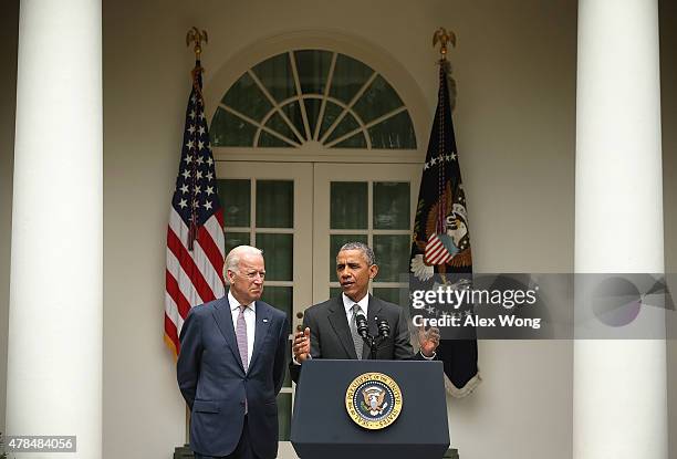 President Barack Obama , flanked by Vice President Joe Biden , gives a statement on the Supreme Court health care decision in the Rose Garden at the...