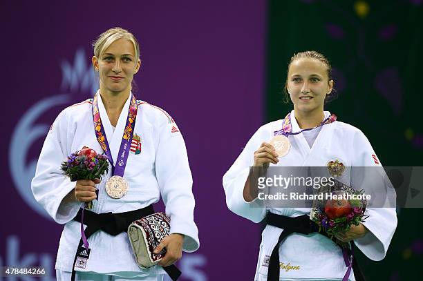 Bronze medalists Eva Csernoviczki of Hungary and Irina Dolgova of Russia pose on the medal podium following the Women's Judo -48kg Finals during day...