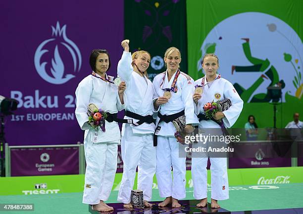 Silver medalist Turkey's Ebru Sahin and Belgium's Charline van Snick pose after their women's -48kg judo final match at the Baku 2015 European Games,...