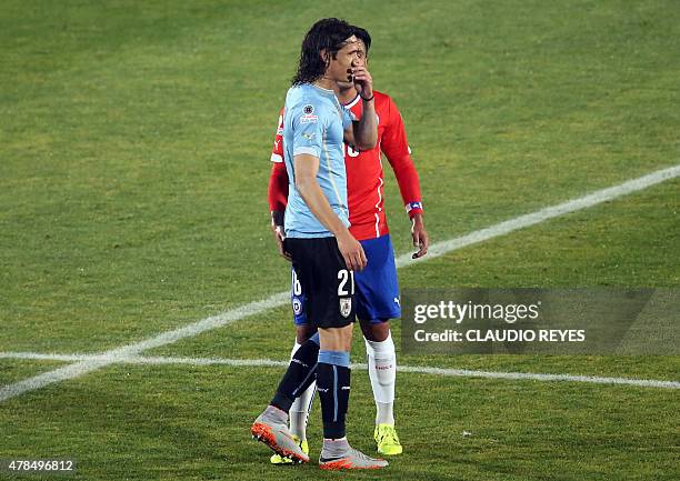 Graphic content / TOPSHOT - Chile's football team defender Gonzalo Jara provokes Uruguay's Edinson Cavani during their Copa America 2015...