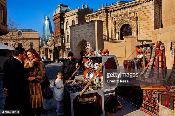 March 26 Old City, Baku, Azerbaijan. An Azerbaijani couple is posing for a video-clip in the Old City of Baku with their daughter. They stop at an...